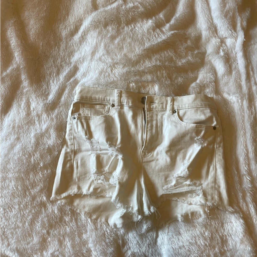 Distressed white jean shorts